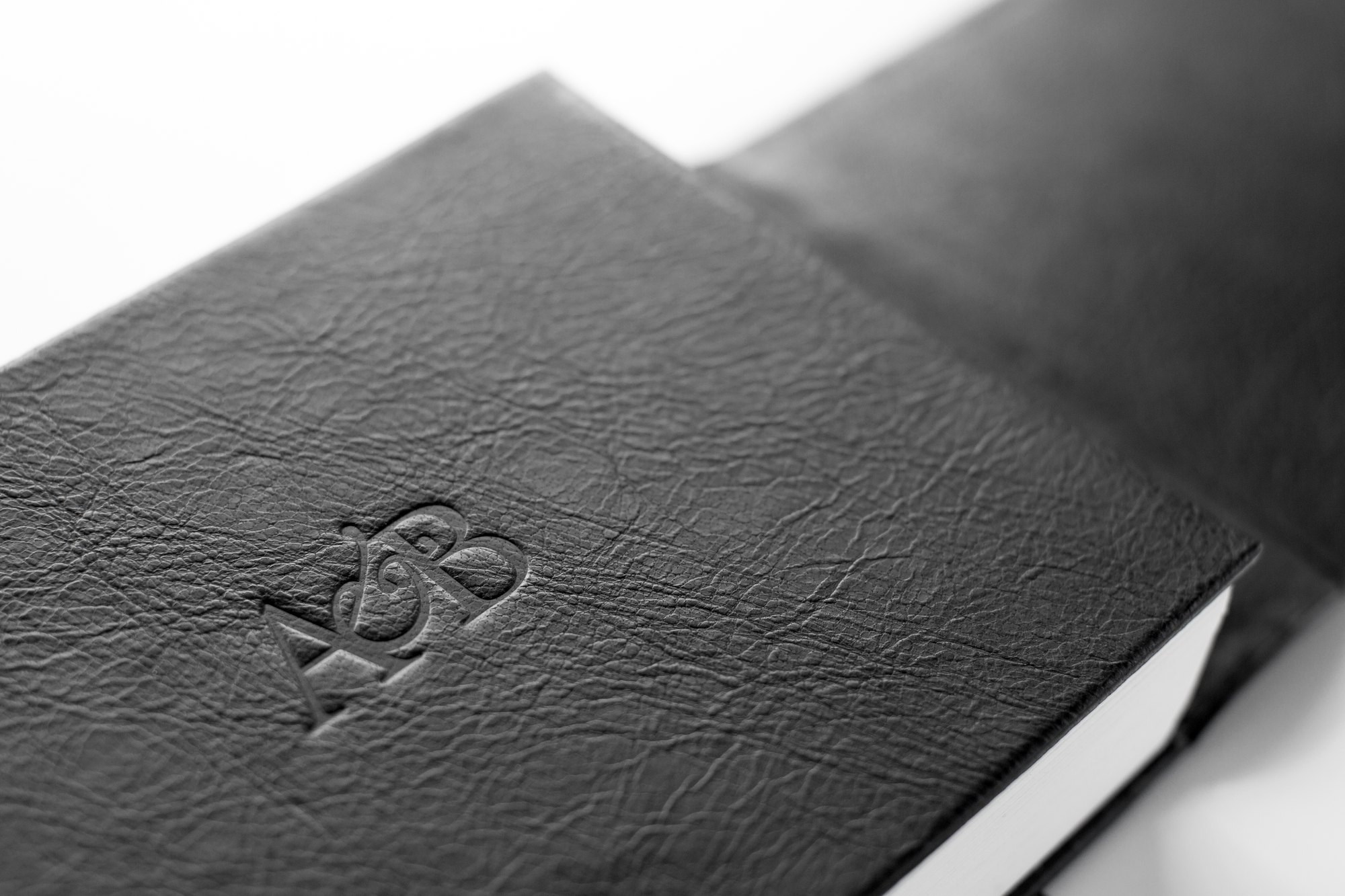 A couple's initials embossed into a full-grain leather album cover