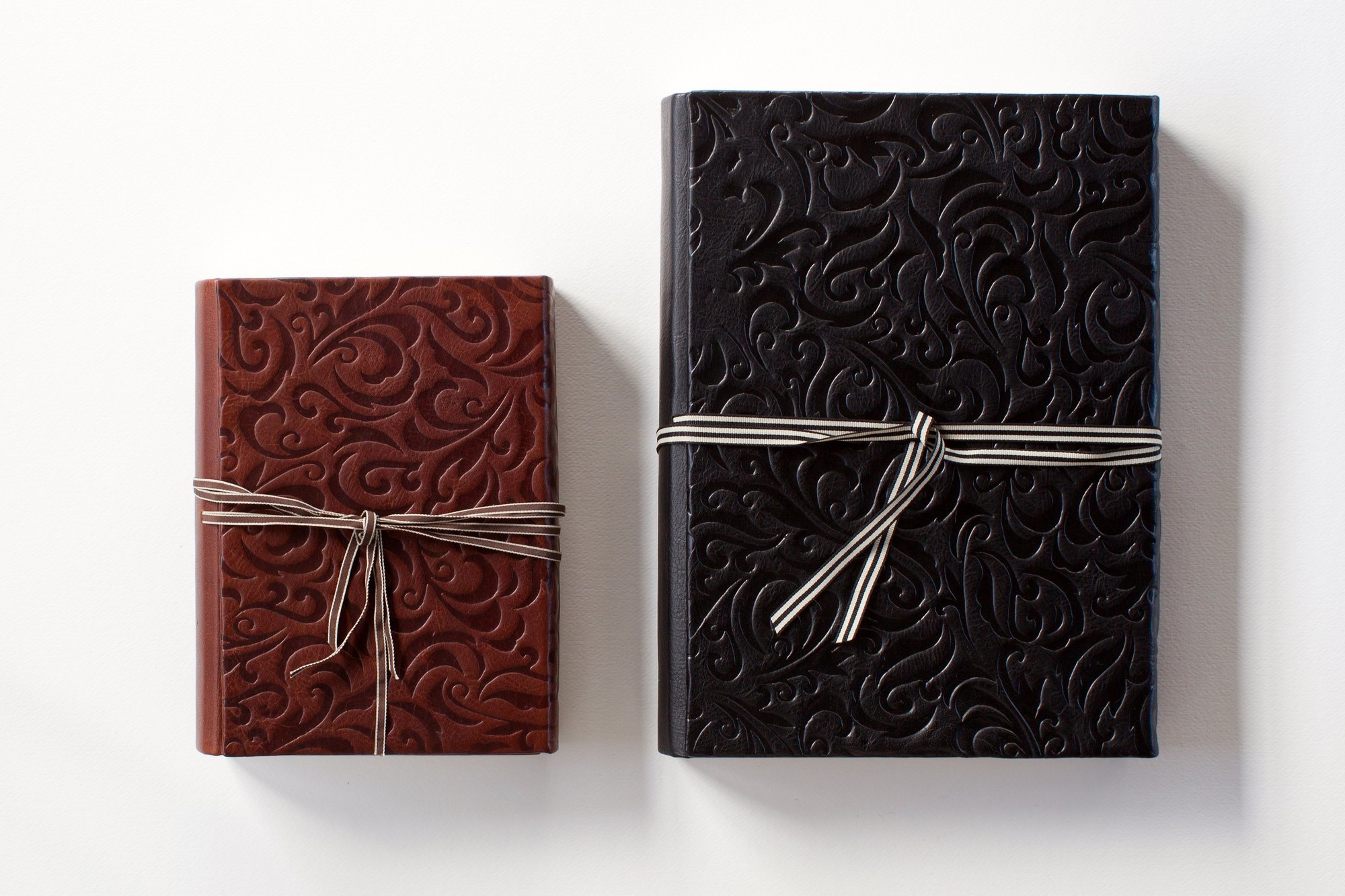 Hand-bound leather Queensberry albums tied with ribbon
