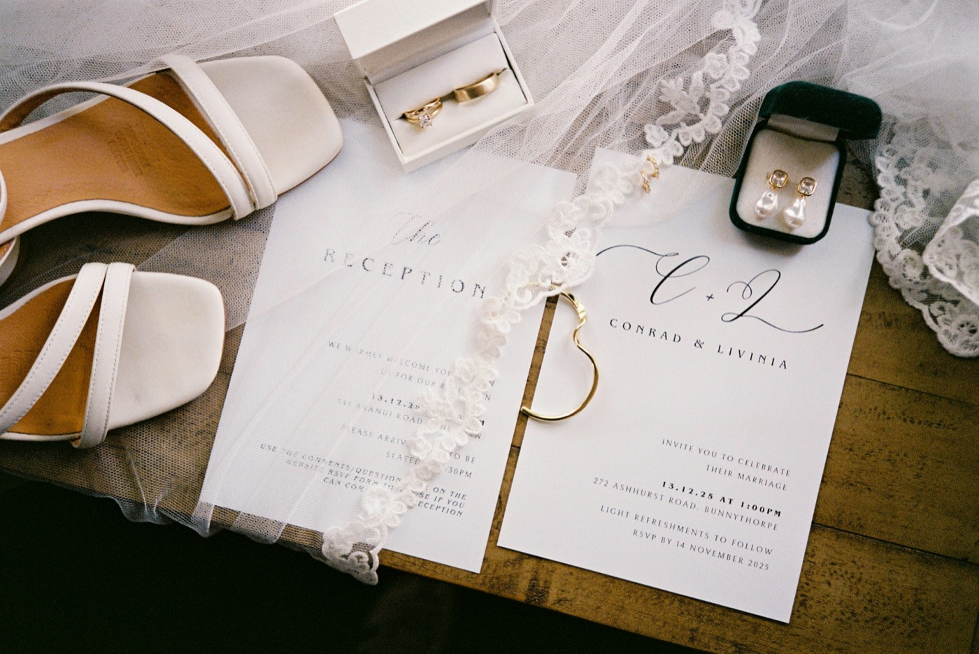 35mm film photograph of wedding invitations, rings and details