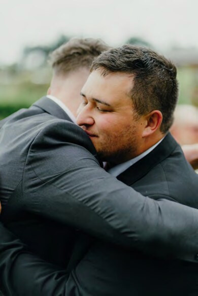Groom embracing a guest