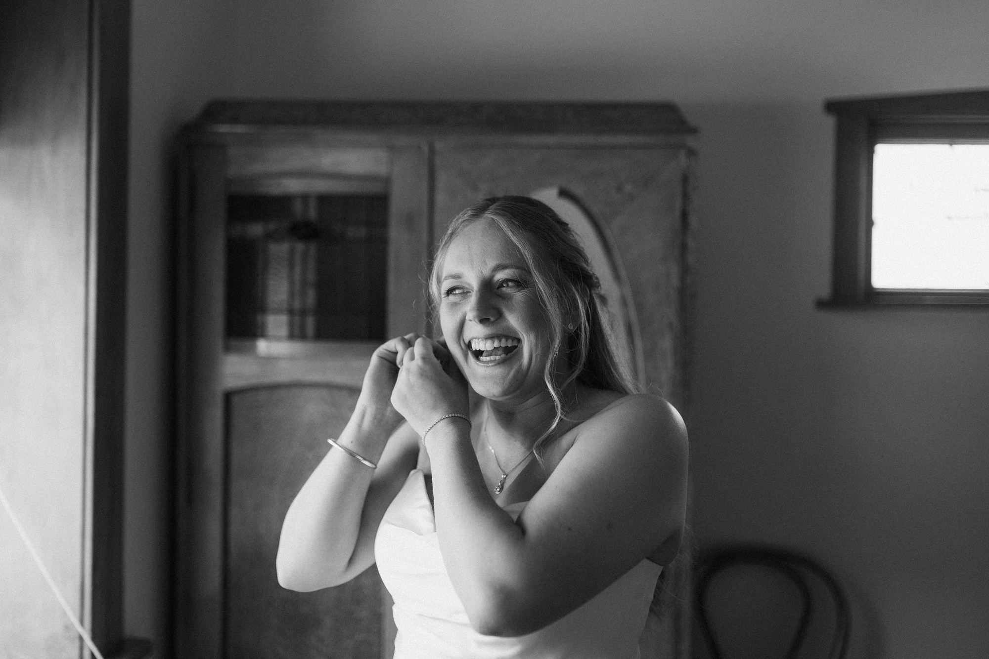 Bride putting on her earrings