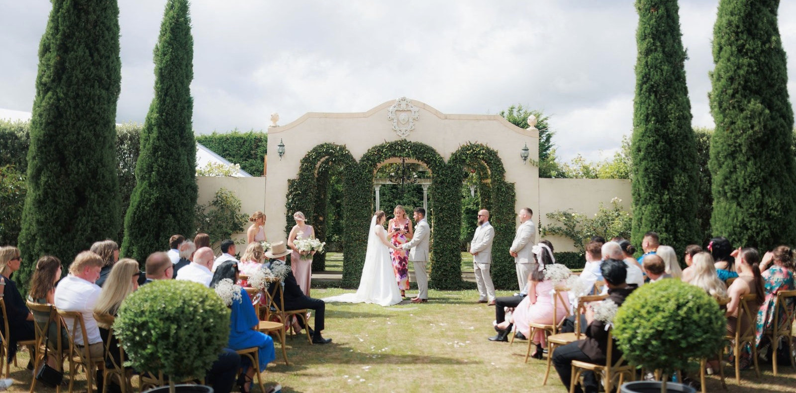 The ceremony beneath a floral arch