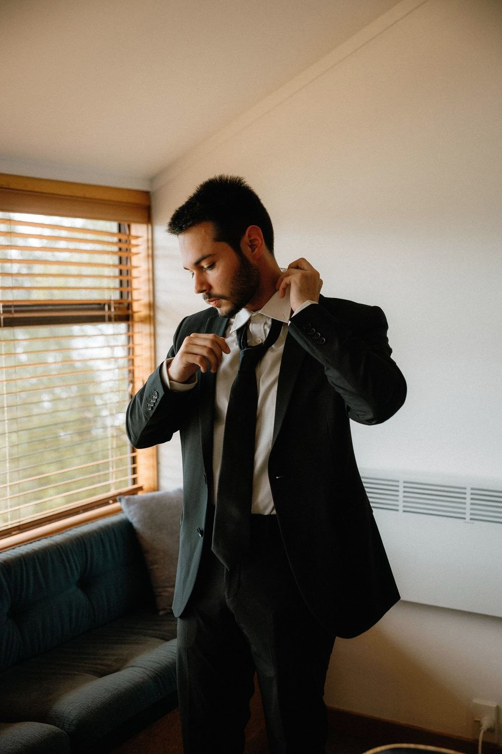 Groom fixing his tie